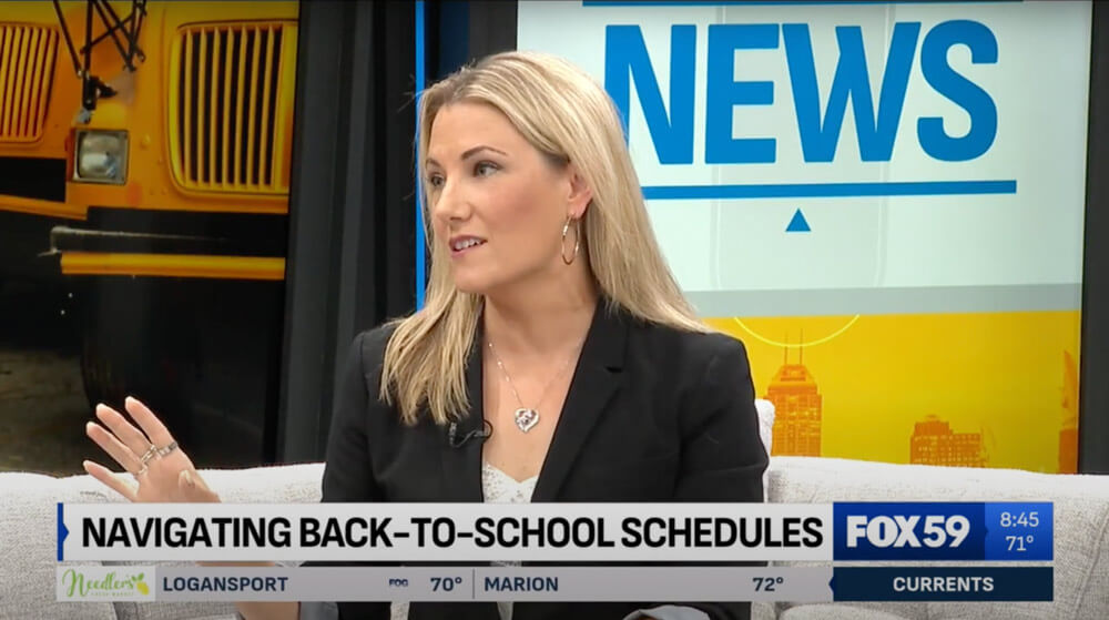 Elyssa on set in front of a school bus background.